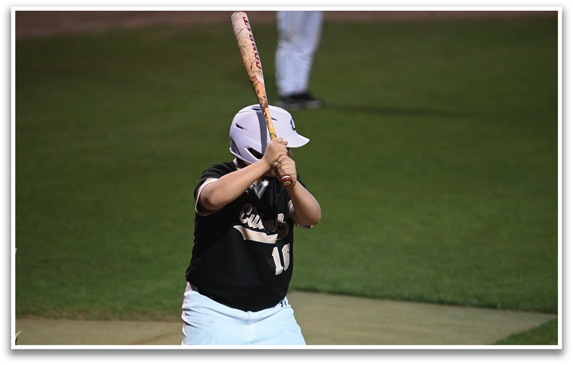 A baseball player is holding a bat, ready to swing at a pitch. AI generated content