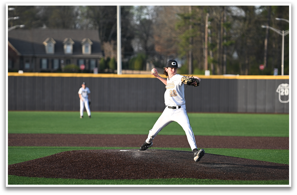A baseball player in a white uniform is pitching a ball on a field. AI generated content