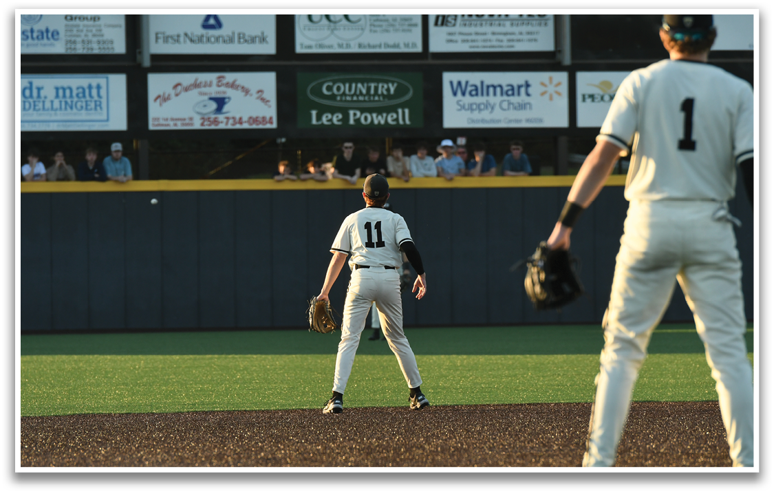 Two baseball players on a field, one wearing a number 11 jersey. AI generated content