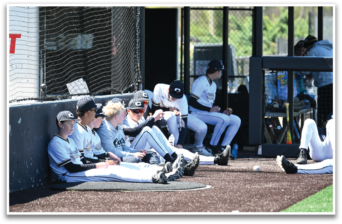 A group of baseball players are sitting on the ground, some of them wearing sunglasses. AI generated content
