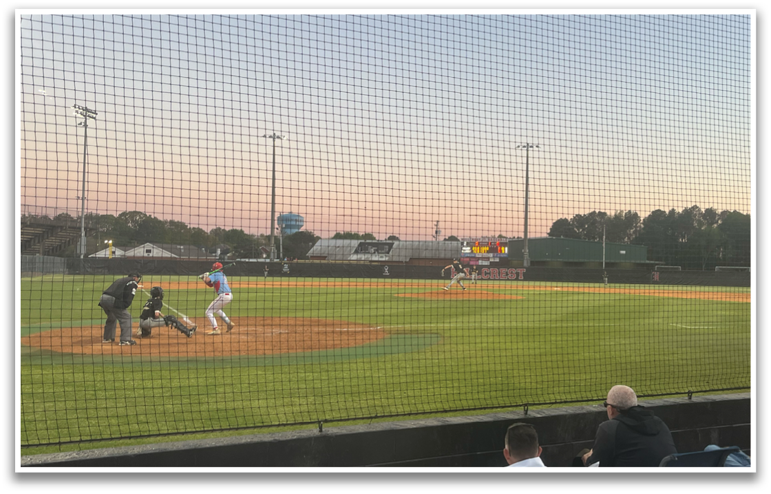 A baseball game is taking place with a batter, catcher, and umpire. The batter is holding a baseball bat, ready to swing. AI generated content