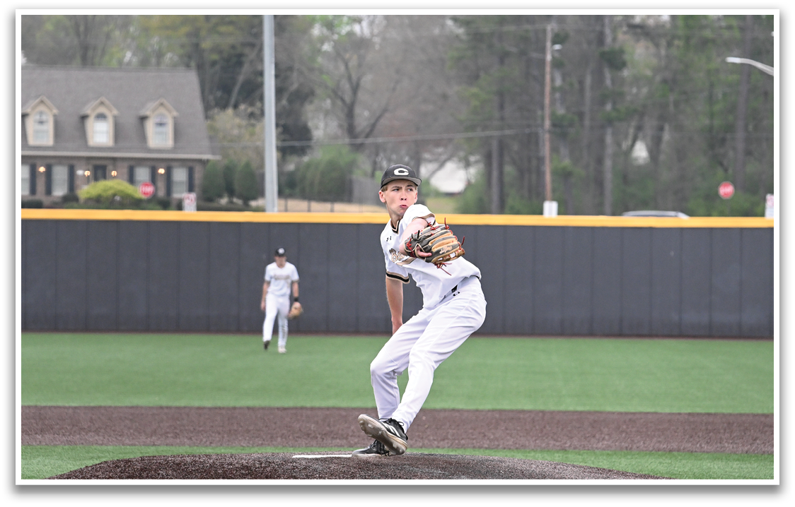 A baseball player in a white uniform is pitching a ball on a field. AI generated content