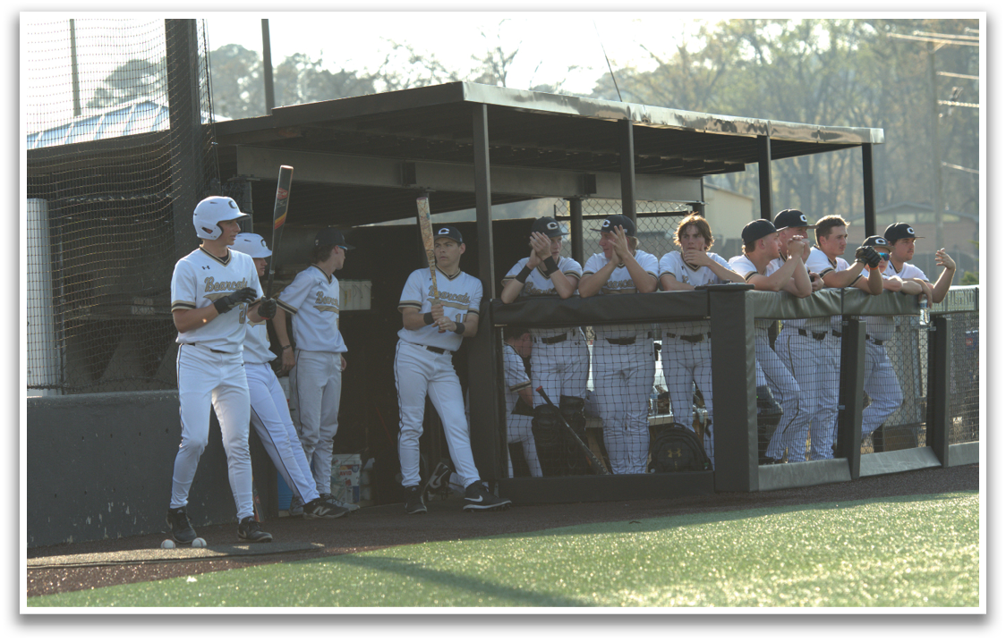 Baseball players in uniforms are sitting on a bench, watching the game. AI generated content