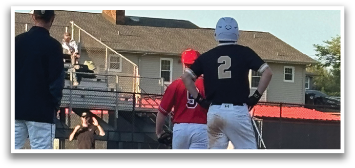 Two baseball players are standing on the field, one wearing a red shirt and the other wearing a black shirt. They are both holding baseball bats. AI generated content