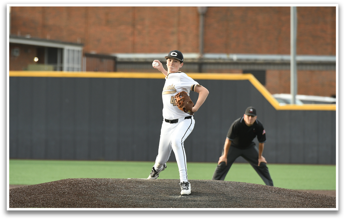 A baseball player in a white uniform is on the mound, preparing to throw the ball. The umpire is behind him, ready to make a call. AI generated content