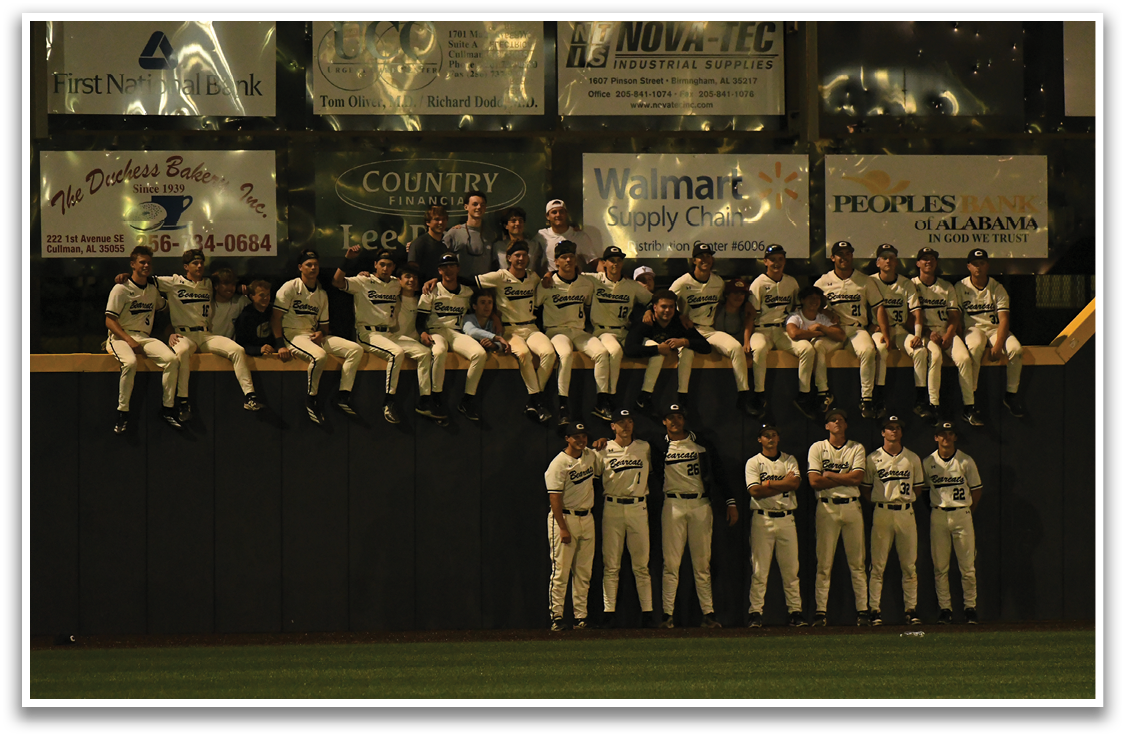 A baseball team is sitting on a wall, wearing their uniforms. AI generated content