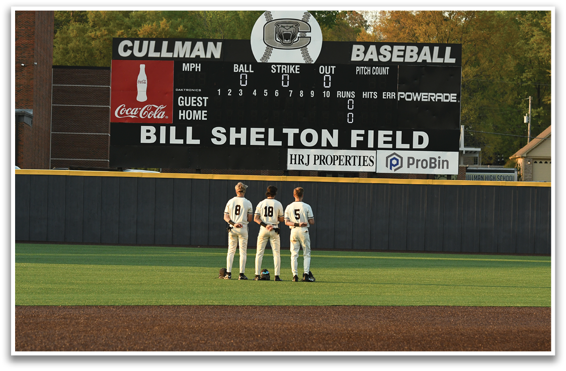 Two men are standing on a baseball field, looking up at a scoreboard. AI generated content