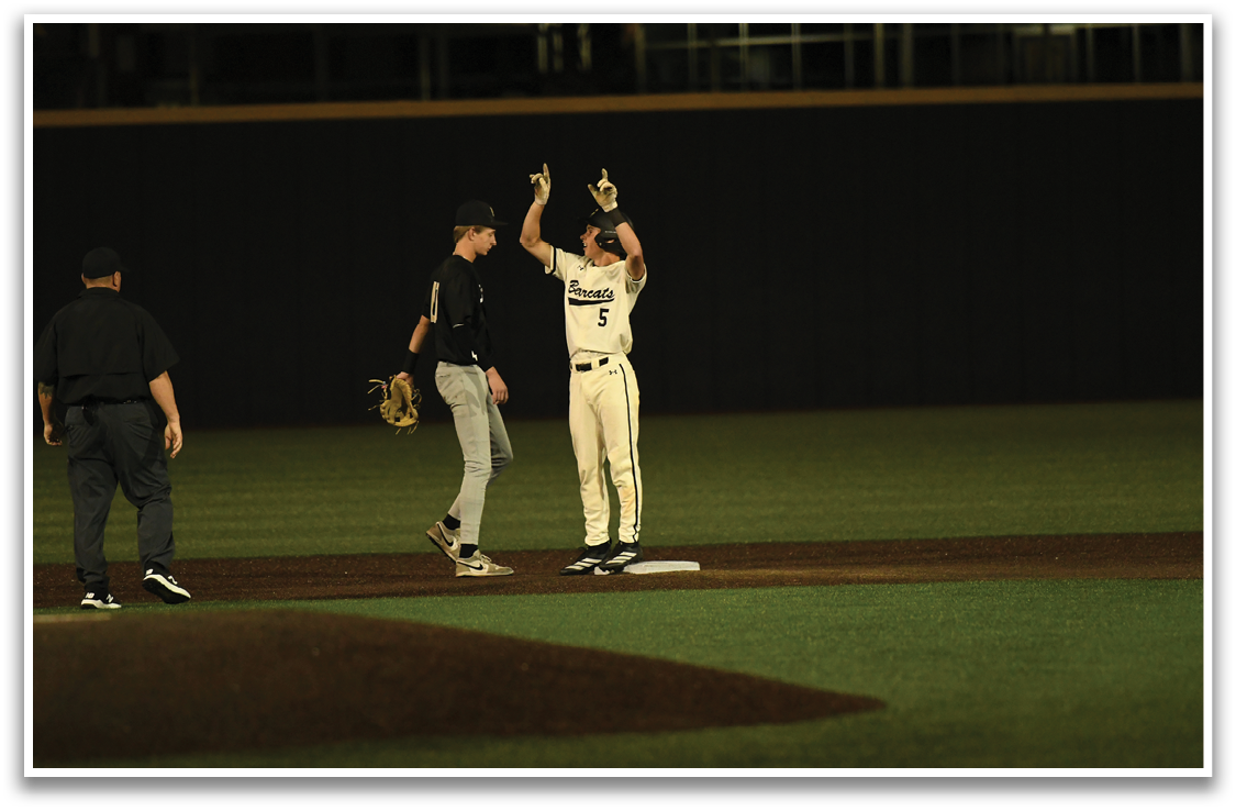 A baseball player is holding his glove up in the air, celebrating a successful play. AI generated content
