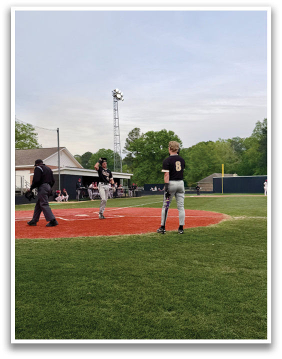A baseball game is taking place with a batter, catcher, and umpire on the field. The batter is holding a baseball bat and preparing to swing. AI generated content