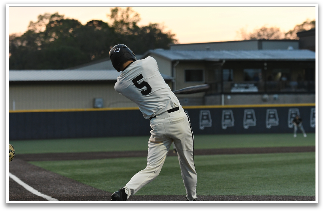 A baseball player is swinging a bat on a field. AI generated content