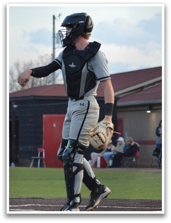 A baseball player in a grey uniform is standing on the field, holding a bat. AI generated content