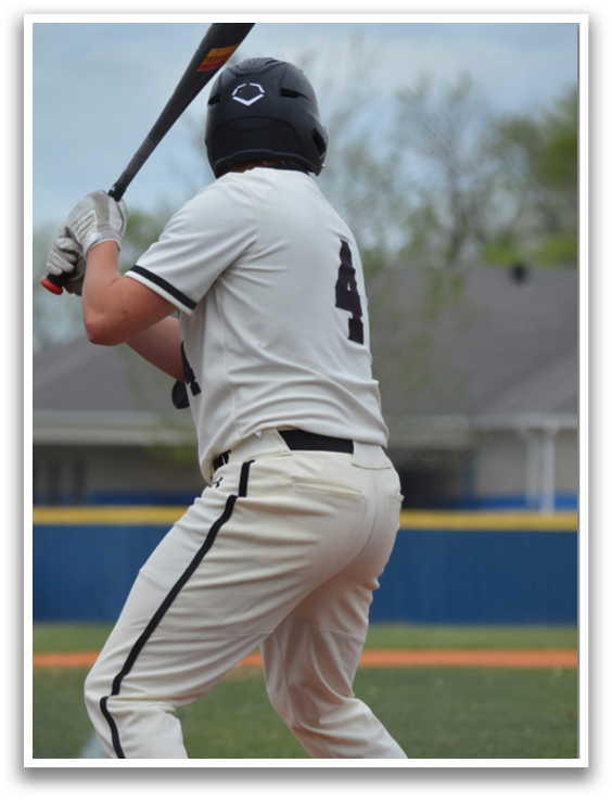 A baseball player in a white uniform is swinging a bat, preparing to hit the ball. AI generated content