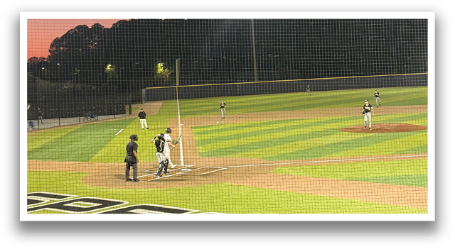 A baseball player in a black shirt and white pants is holding a bat, preparing to hit the ball. The player is surrounded by his teammates, who are watching and cheering him on. AI generated content