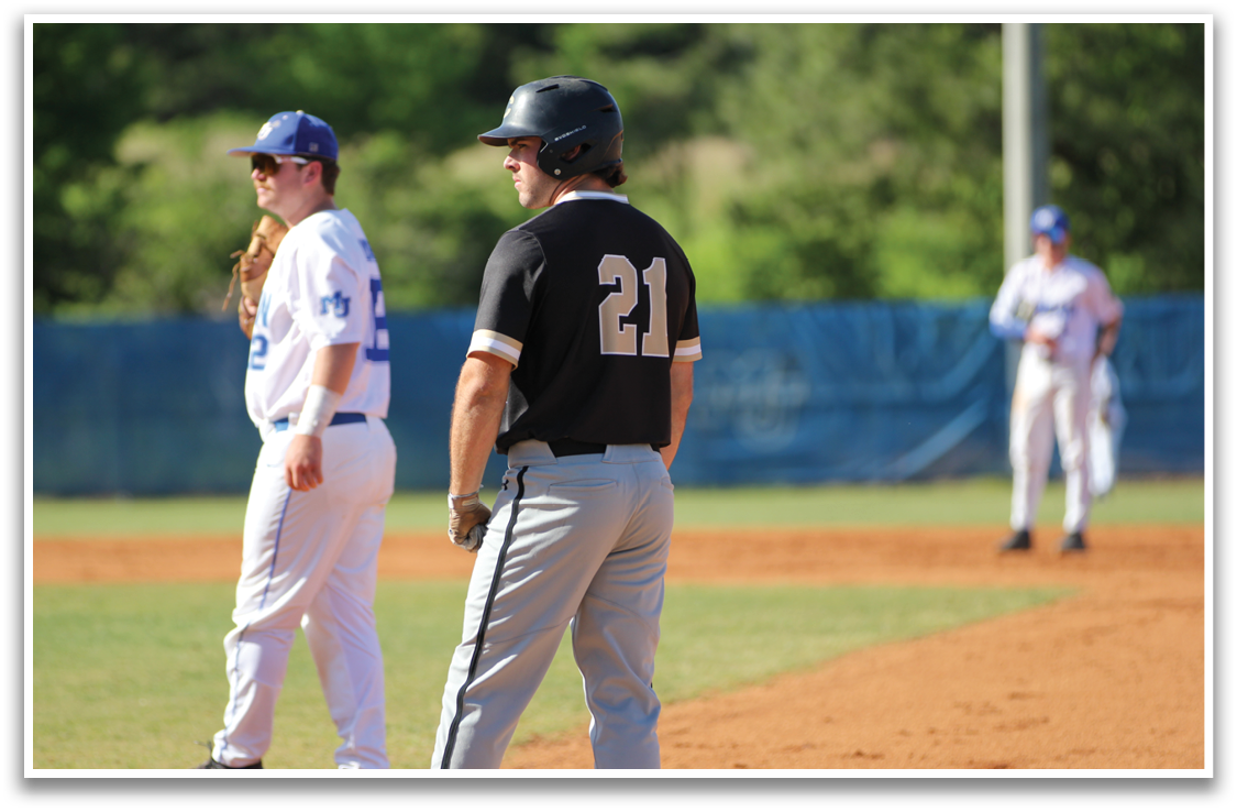 A baseball player wearing a black shirt and number 22 stands on the field. AI generated content
