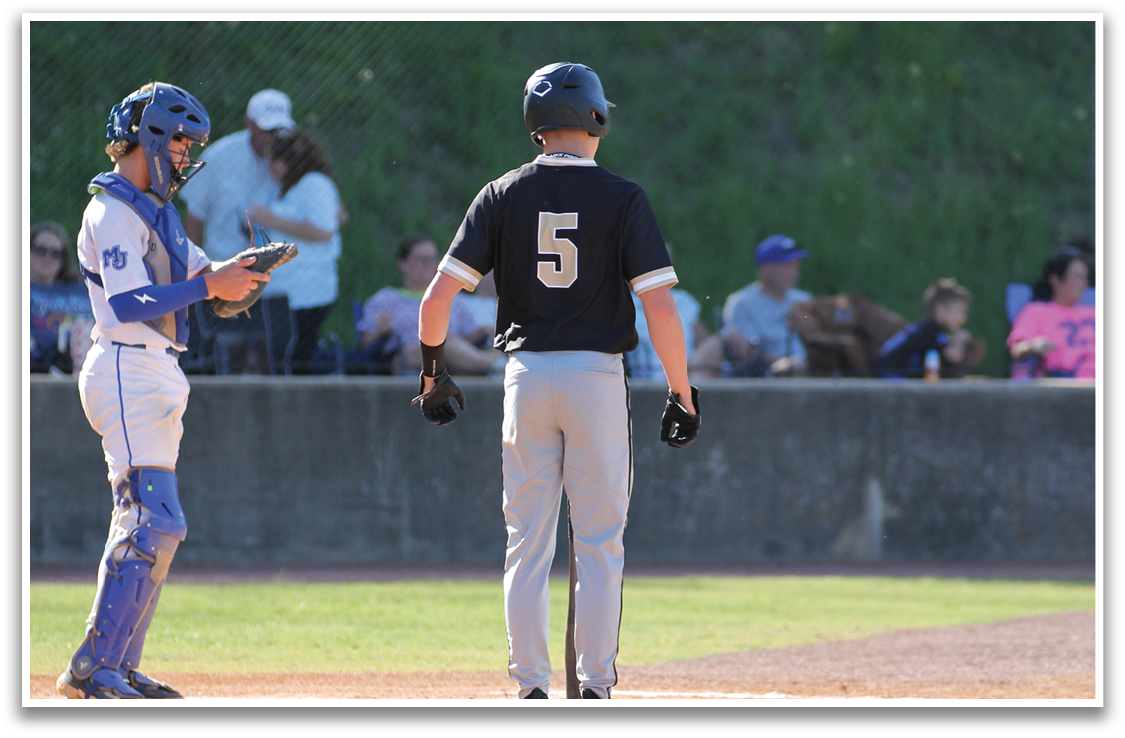 A baseball player wearing a black shirt and the number 5 stands on the field. AI generated content