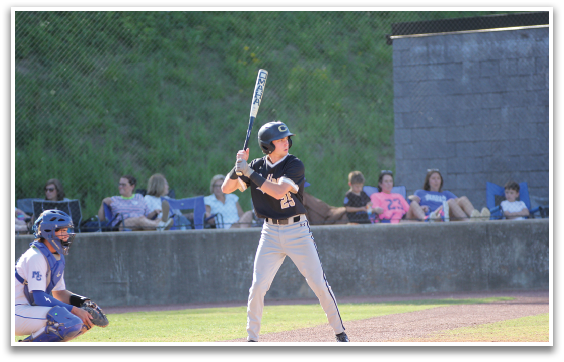 A baseball player is at bat, holding a bat and waiting for the pitch. AI generated content