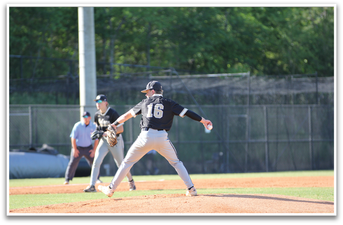 A baseball player in a black shirt and grey pants is pitching a ball. AI generated content