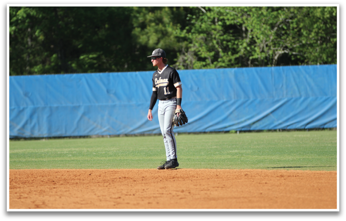 A baseball player is standing on the field, wearing a black shirt and a baseball glove. AI generated content