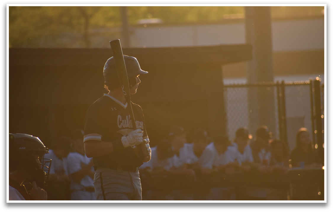 A baseball player holding a bat, standing on a field with other players. AI generated content