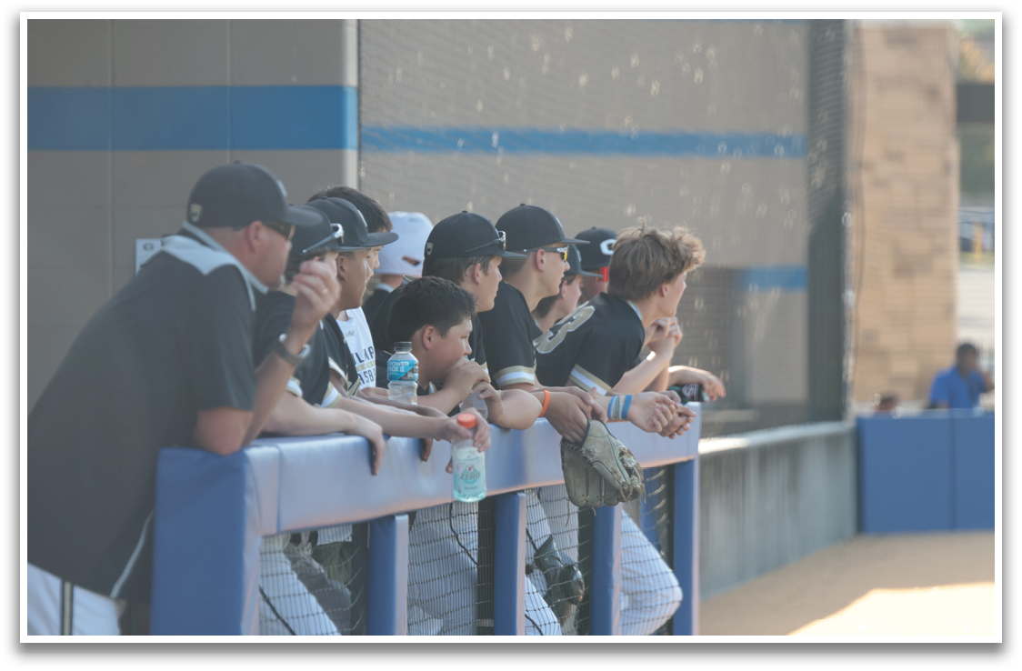 A group of young men are sitting on a bench, watching a baseball game. AI generated content