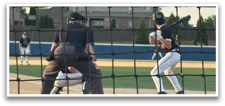 A baseball game is taking place with a batter, catcher, and umpire. The batter is holding a baseball bat, ready to swing. AI generated content