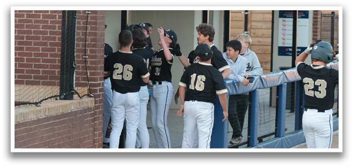 A group of baseball players huddle together on the field, with some of them wearing numbered jerseys. AI generated content