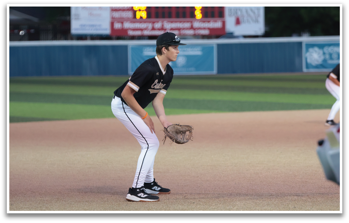 A baseball player in a black shirt and white pants is holding a catcher's mitt, ready to catch the ball. AI generated content
