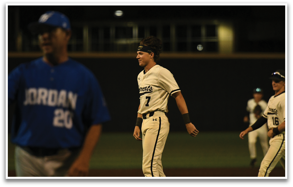 A baseball player wearing a white and black uniform stands on the field. AI generated content