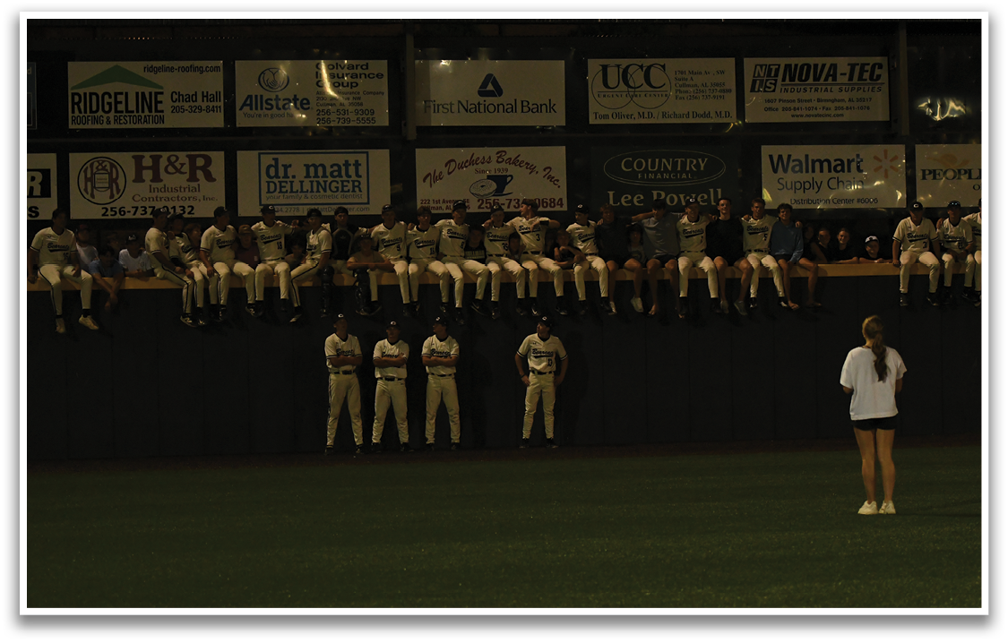 A group of people are standing on a baseball field. AI generated content