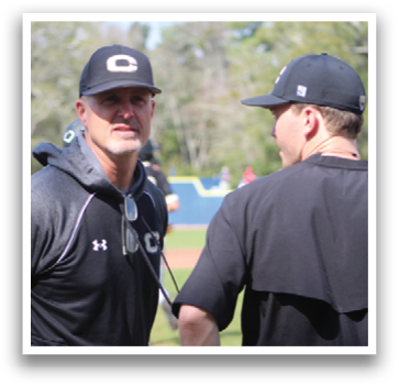 Two men wearing black shirts are talking to each other. One man is wearing a black hat and the other is wearing a black shirt. AI generated content