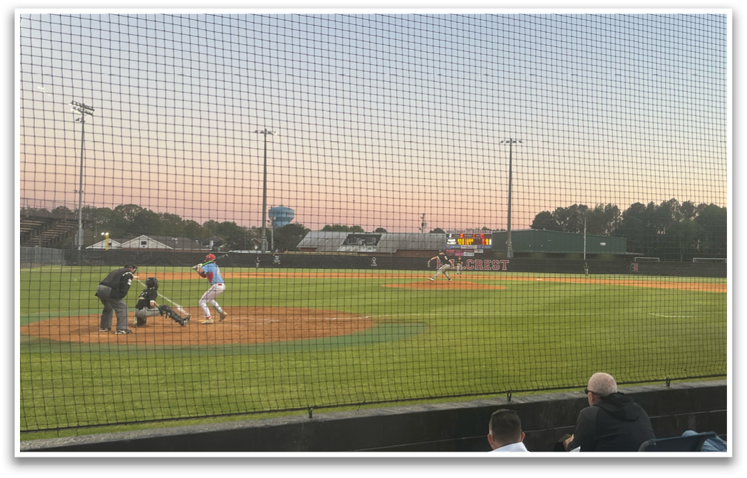 A baseball game is taking place with a batter, catcher, and umpire. The batter is holding a baseball bat, ready to swing. AI generated content