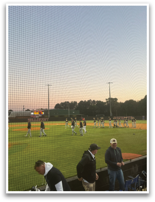A group of people are standing on a baseball field. AI generated content