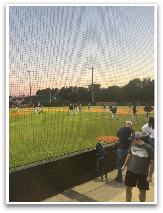 A baseball game is taking place with a crowd of people watching. AI generated content