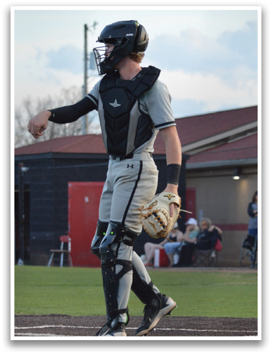 A baseball player in a grey uniform is standing on the field, holding a bat. AI generated content