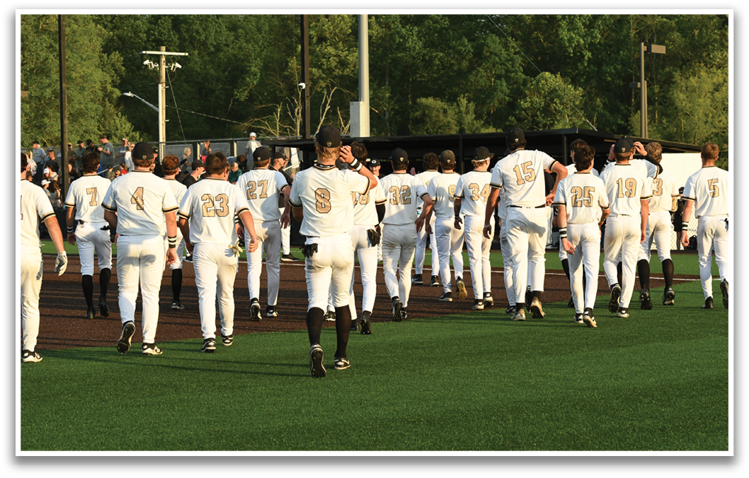 A group of baseball players walking on a field. Description generated by AI