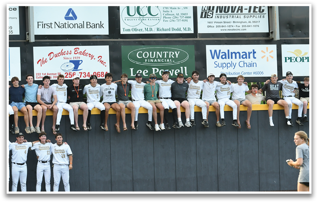 A group of people are sitting on a wall. Description generated by AI