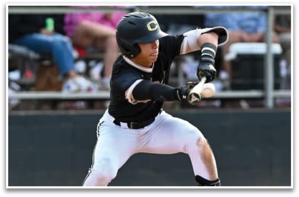 A baseball player in a black and gold uniform is swinging a bat. Description generated by AI