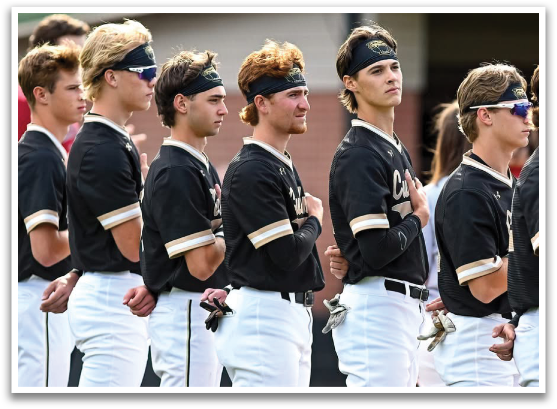 A group of young men wearing black and white uniforms. Description generated by AI