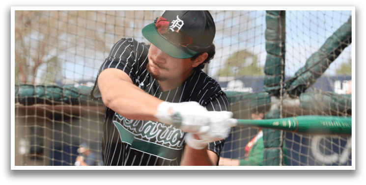A baseball player wearing a black and green jersey. Description generated by AI