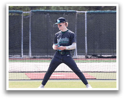 A boy wearing a black and white baseball uniform. Description generated by AI