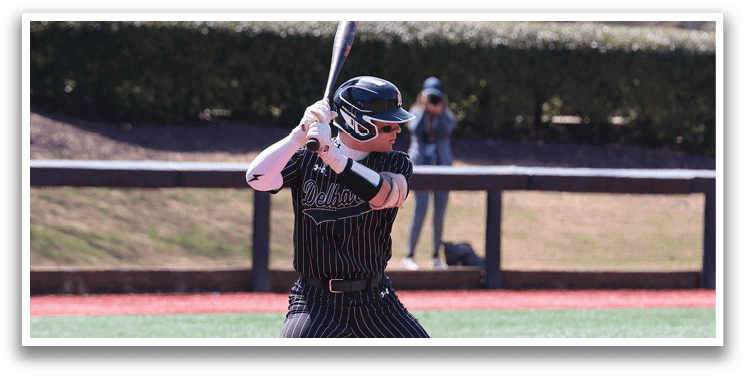 A baseball player is holding a bat and getting ready to hit a ball. Description generated by AI