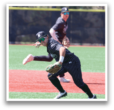 A baseball player in a black and white uniform is running towards a base. Description generated by AI