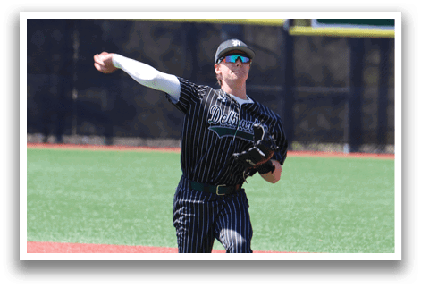 A baseball player wearing a black and white uniform with a green stripe. Description generated by AI