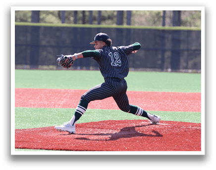 A baseball player in a black and green striped uniform is pitching a ball. Description generated by AI