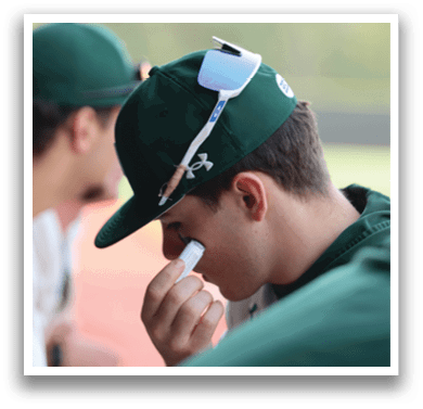 A man with a green hat and sunglasses is holding his nose. Description generated by AI