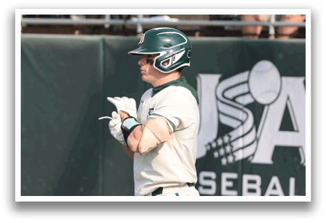 A baseball player wearing a green helmet and white uniform. Description generated by AI