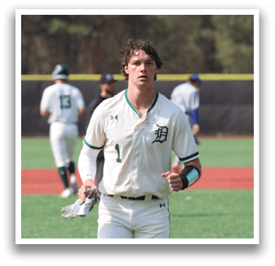 A baseball player in a white uniform is walking on the field. Description generated by AI