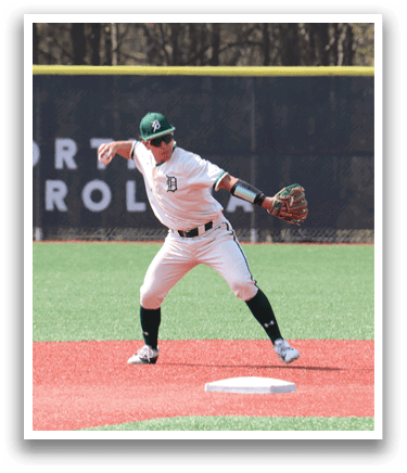 A baseball player in a white uniform is catching a ball. Description generated by AI