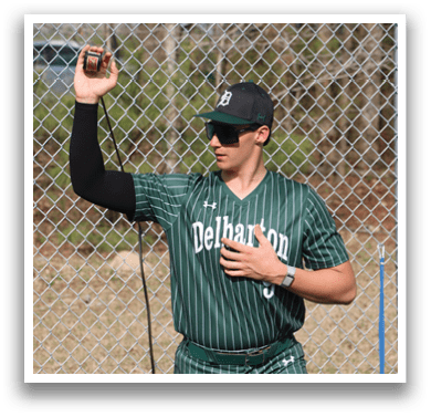 A man wearing a green and white striped baseball uniform. Description generated by AI