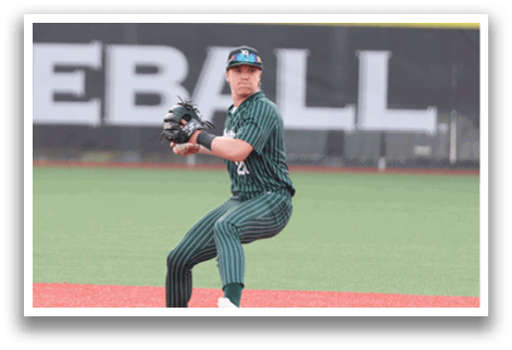 A baseball player in a green and white uniform is ready to catch a ball. Description generated by AI